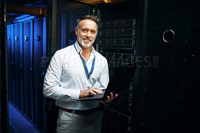 Buy stock photo Portrait of a mature man using a laptop while working in a server room