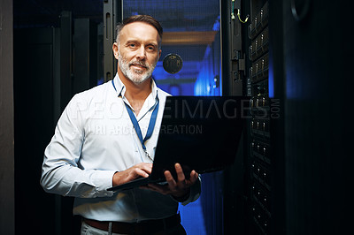 Buy stock photo Portrait of a mature man using a laptop while working in a server room