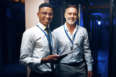 Buy stock photo Portrait of two technicians using a digital tablet while working in a server room