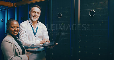 Buy stock photo Portrait of two technicians using a laptop while working in a server room