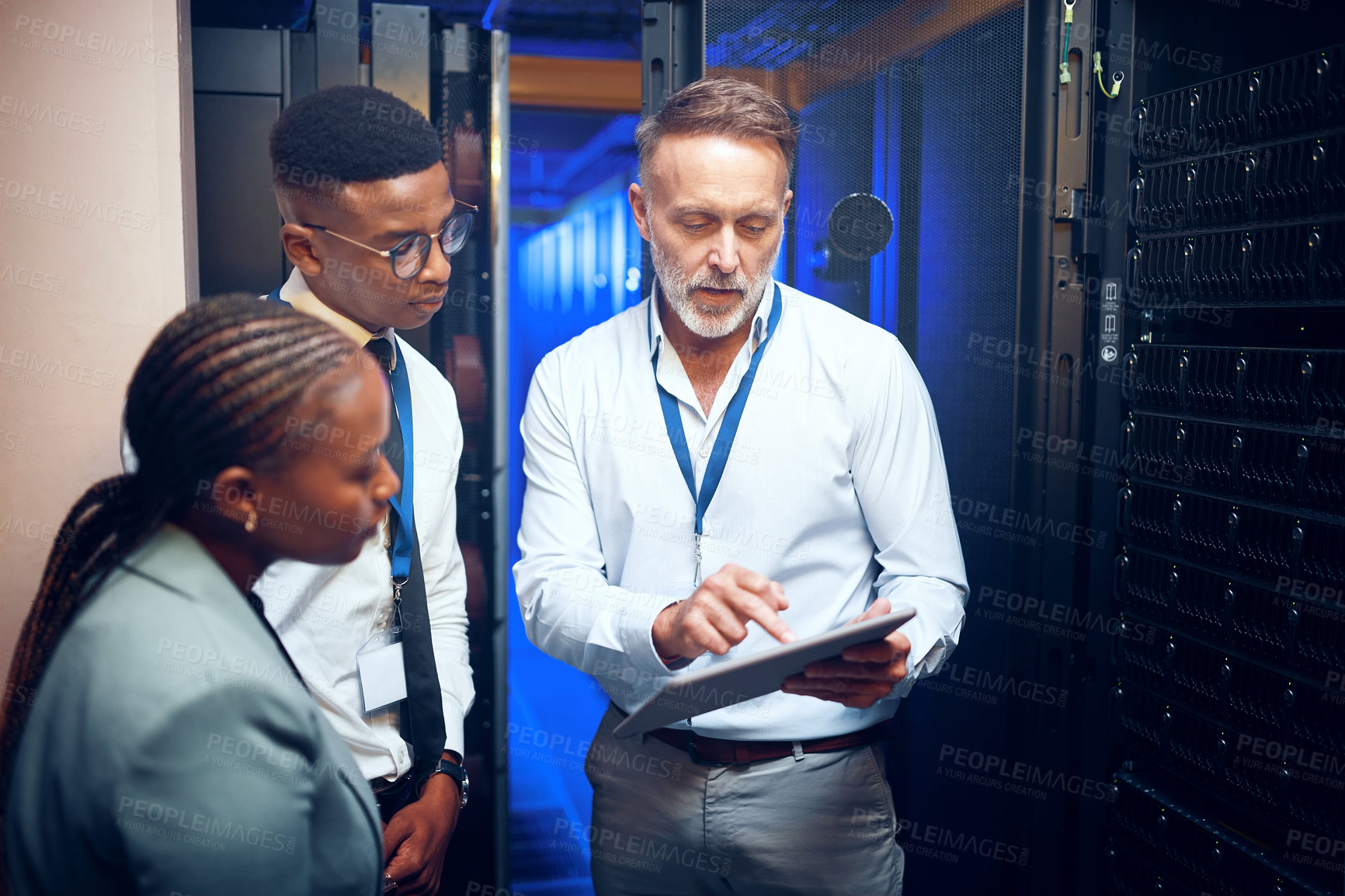 Buy stock photo Reading, technician and manager with tablet in server room, upgrade proposal or software discussion. Tech, team or people planning for data center maintenance, system feedback or capacity improvement