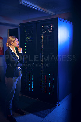 Buy stock photo Shot of a young woman looking thoughtful while working in a server room