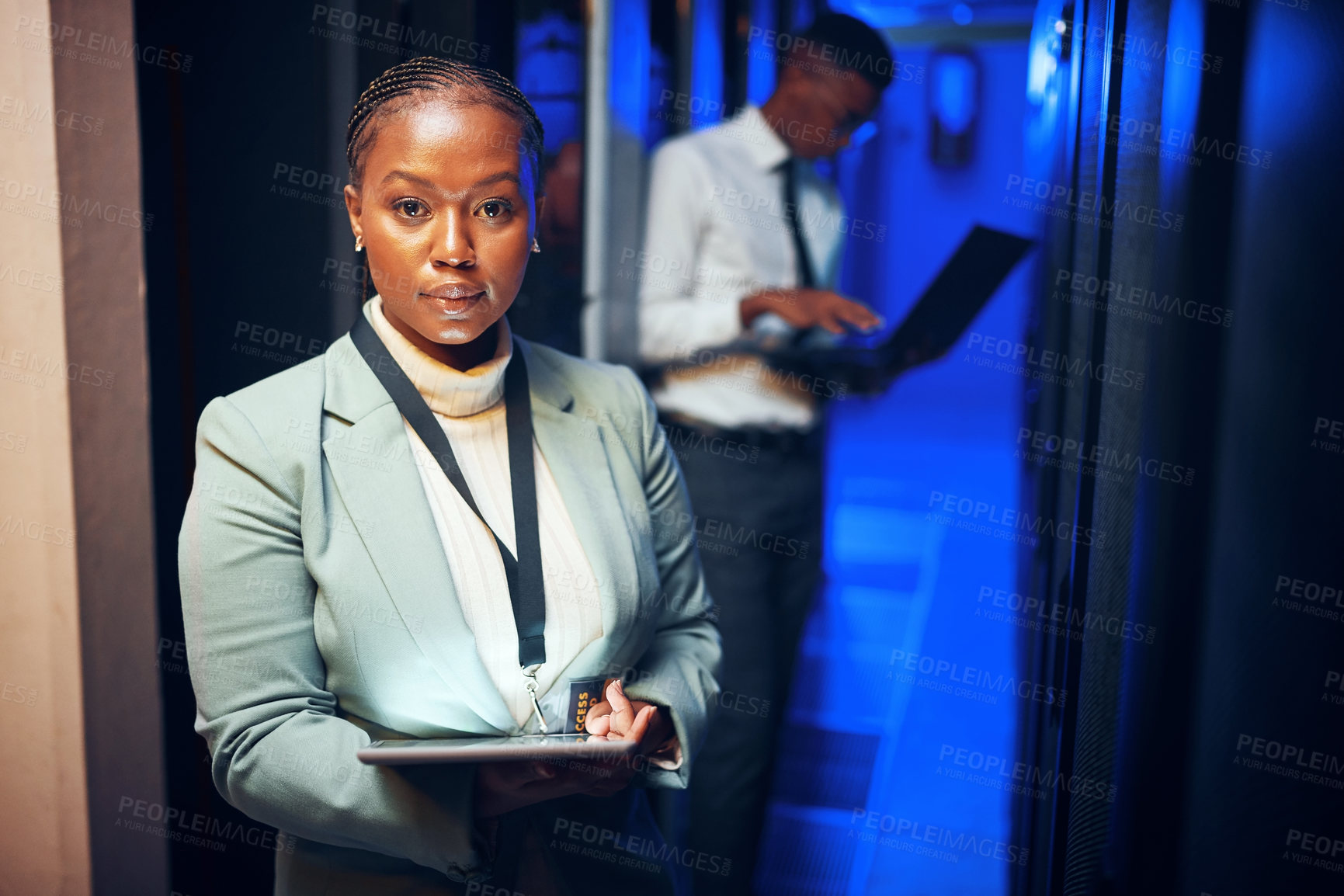 Buy stock photo Portrait of a young woman using a digital tablet while working in a server room
