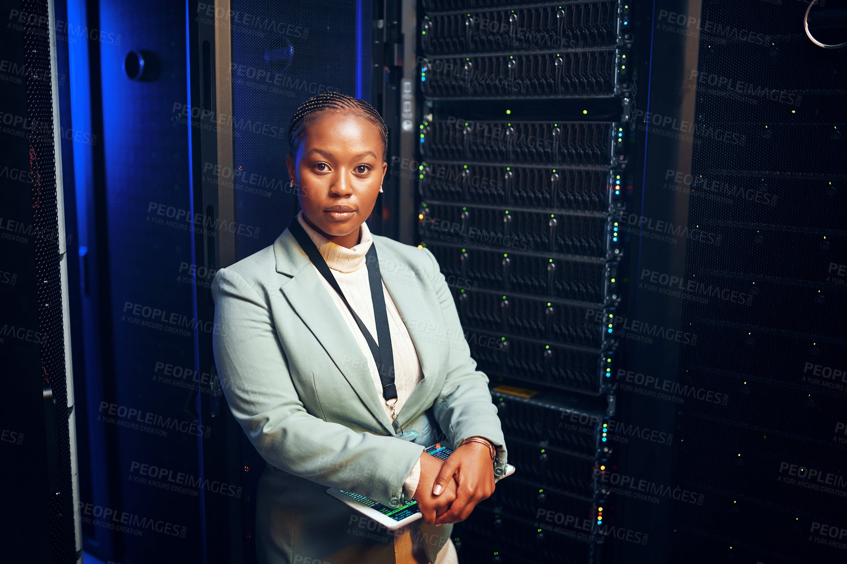 Buy stock photo Portrait of a young woman holding a digital tablet while working in a server room