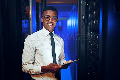 Buy stock photo Portrait of a young man using a digital tablet while working in a server room