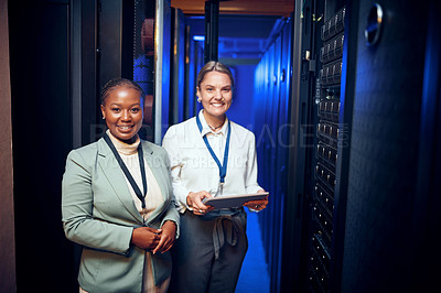 Buy stock photo Portrait of two technicians using a digital tablet while working in a server room