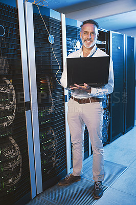 Buy stock photo Portrait of a mature man using a laptop while working in a server room