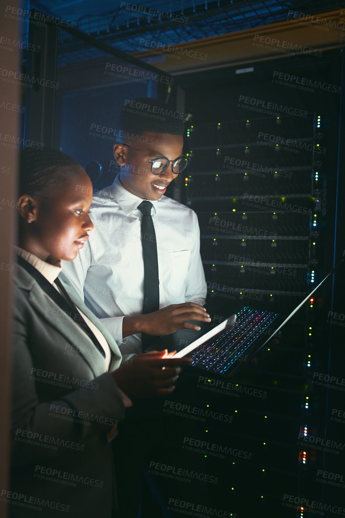 Buy stock photo Maintenance, upgrade or team in server room with tech, network or system inspection in data center. Engineers, laptop or black people in dark, fault detection or collaboration in diagnostic test.