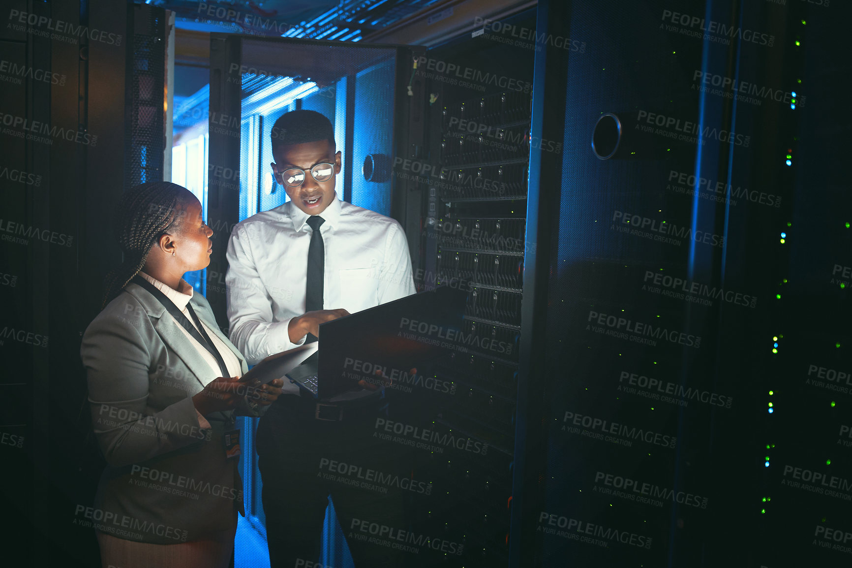 Buy stock photo Inspection, review or engineers in server room with tech, teamwork or system check in data center. Technicians, laptop or black people in dark, fault detection or collaboration in diagnostic test