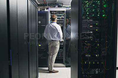 Buy stock photo Rearview shot of a mature man working in a server room