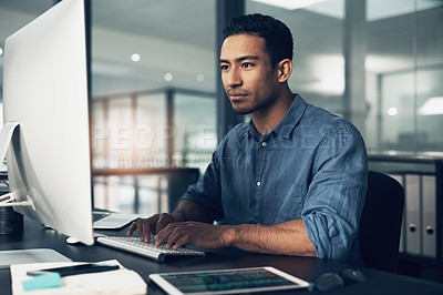 Buy stock photo Typing, man and programmer on computer in office at night for deadline. IT, focus and male coder, engineer or person programming, coding and writing software, development and information technology.