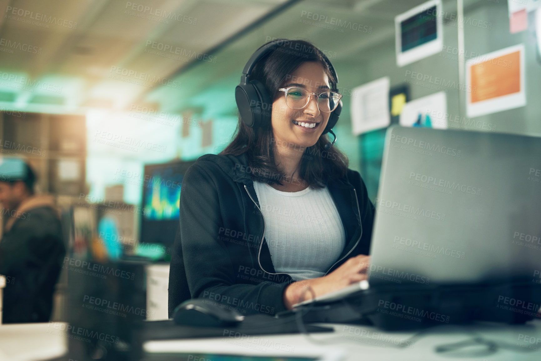 Buy stock photo Shot of a young woman using a headset in a modern office