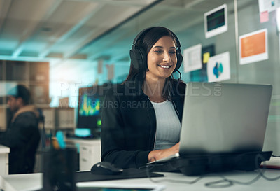 Buy stock photo Shot of a young woman using a headset in a modern office