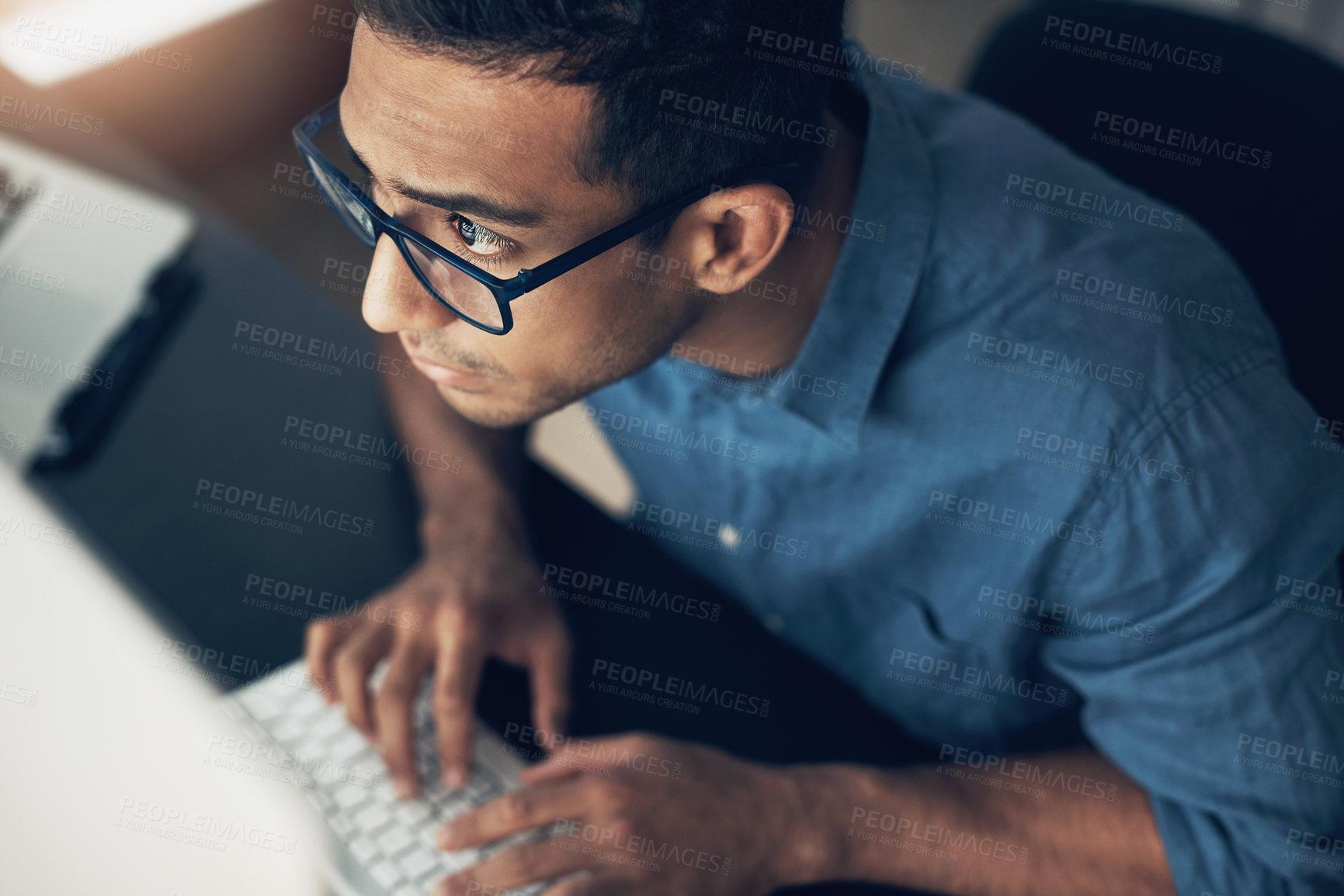 Buy stock photo Cropped shot of a young using a computer in a modern office