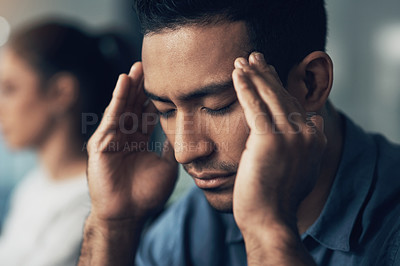 Buy stock photo Closeup shot of a young man suffering from a migraine in a modern office