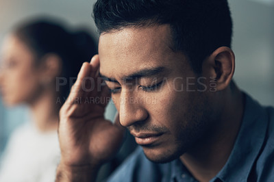Buy stock photo Closeup shot of a young man suffering from a migraine in a modern office