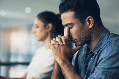Buy stock photo Shot of a young man suffering from a migraine in a modern office