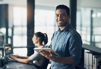 Buy stock photo Portrait of a young man using a digital tablet in a modern office
