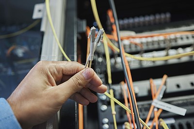 Buy stock photo Shot of an unrecognizable woman working on cables in a server room