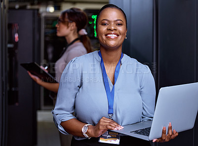 Buy stock photo Cropped portrait of an attractive young female programmer working in a server room with her colleague in the background