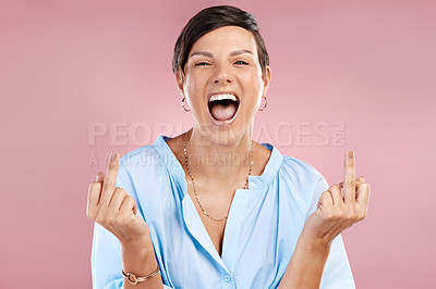 Buy stock photo Cropped portrait of an attractive young woman giving you the finger in studio against a pink background