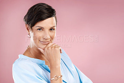 Buy stock photo Cropped portrait of an attractive young woman posing in studio against a pink background