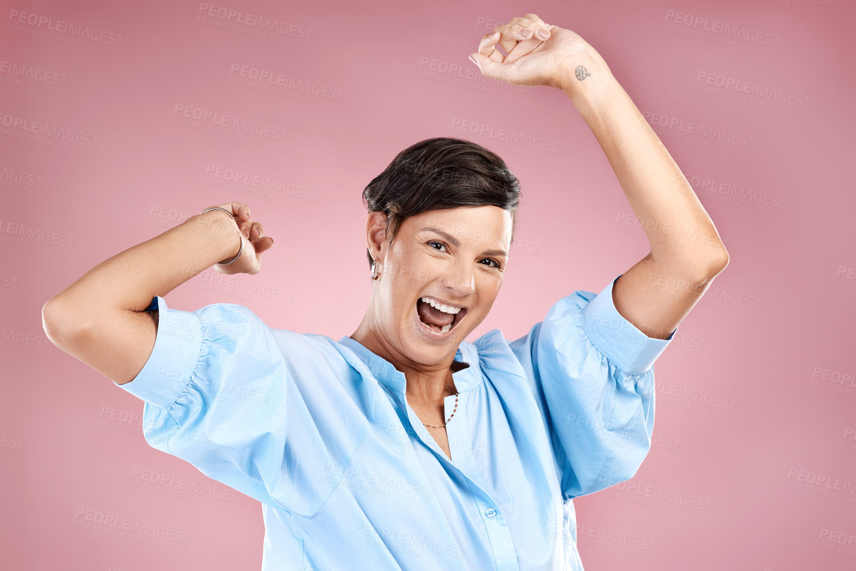 Buy stock photo Cropped portrait of an attractive young woman cheering in studio against a pink background
