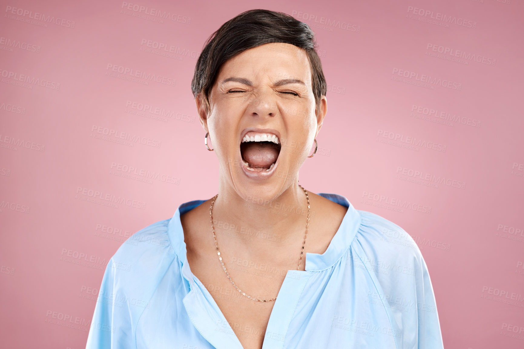 Buy stock photo Cropped shot of an attractive young woman shouting in studio against a pink background