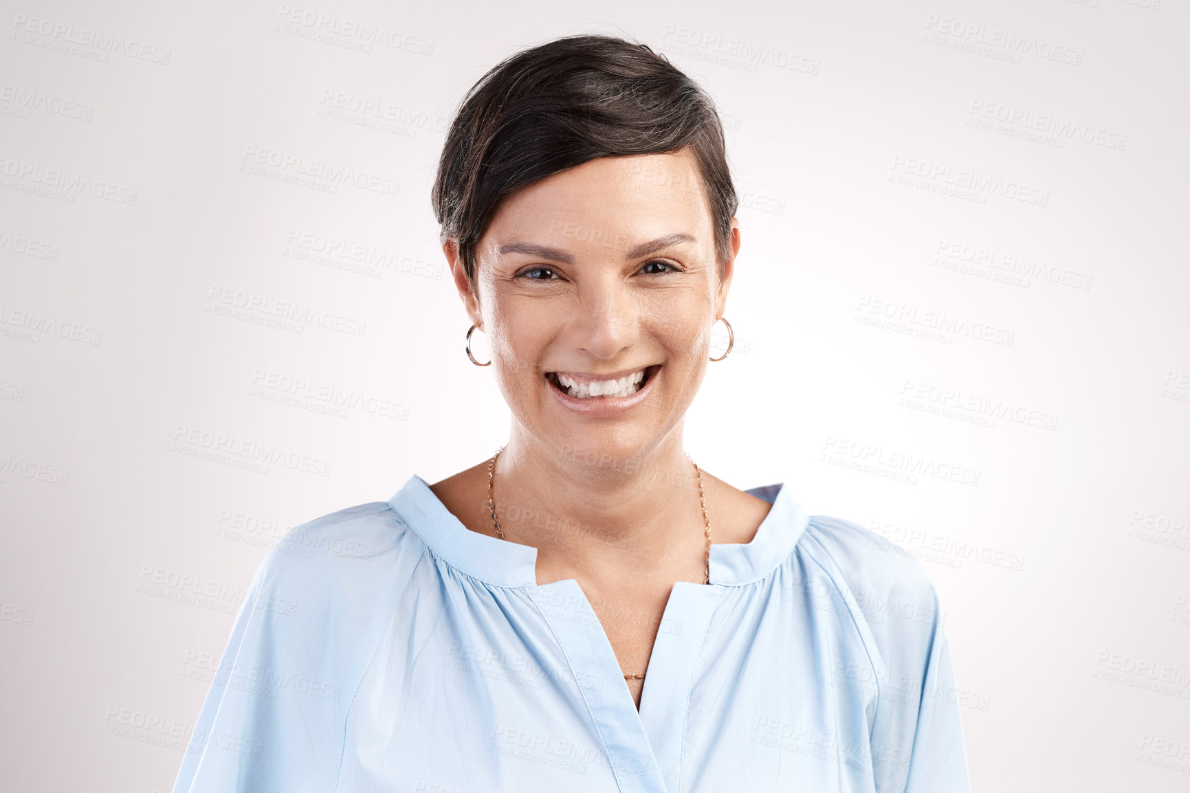 Buy stock photo Cropped portrait of an attractive young woman posing in studio against a grey background