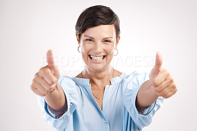 Buy stock photo Cropped portrait of an attractive young woman giving you two thumbs in studio against a grey background