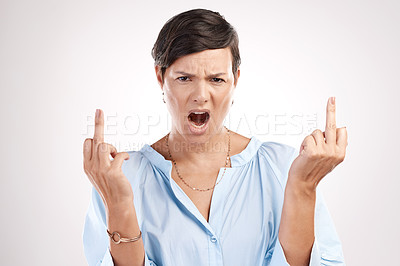 Buy stock photo Cropped portrait of an attractive young woman giving you the finger in studio against a grey background