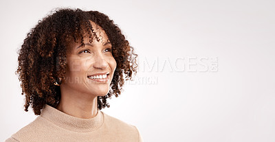 Buy stock photo Cropped shot of an attractive young woman looking thoughtful in studio against a grey background