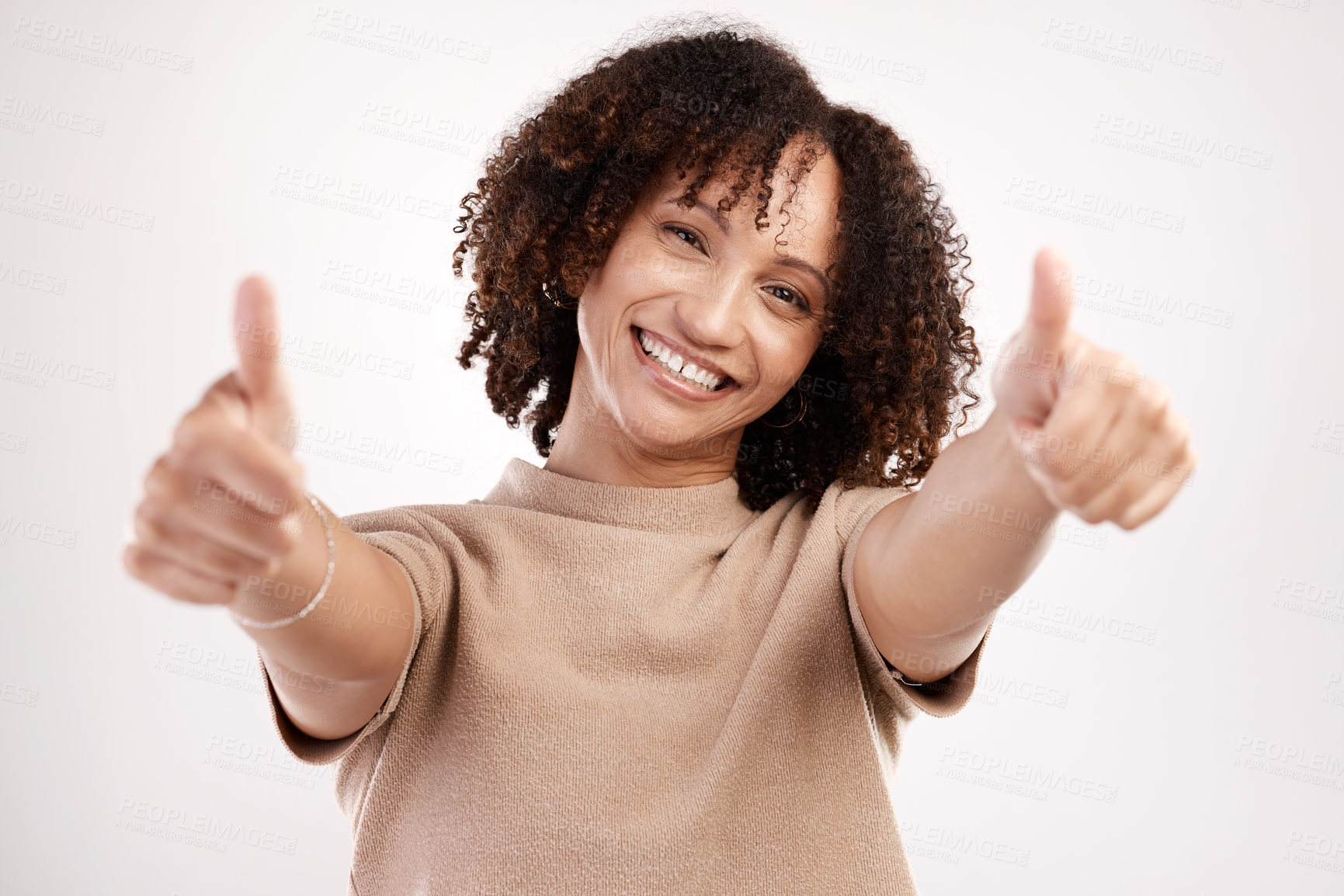 Buy stock photo Cropped portrait of an attractive young woman giving you two thumbs in studio against a grey background