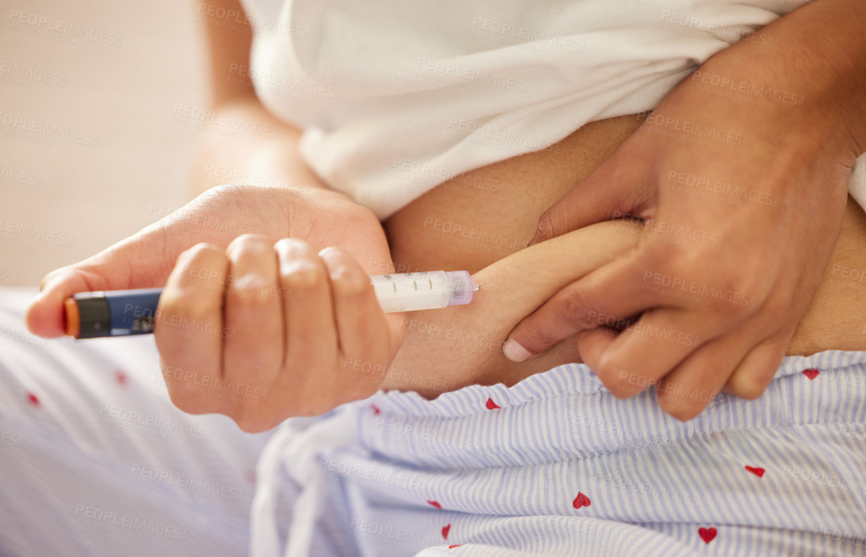 Buy stock photo Closeup shot of an unrecognizable woman injecting herself in the stomach with insulin at home