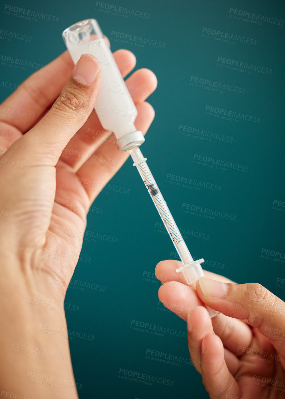 Buy stock photo Cropped shot of an unrecognizable woman drawing a dose of insulin into a syringe at home