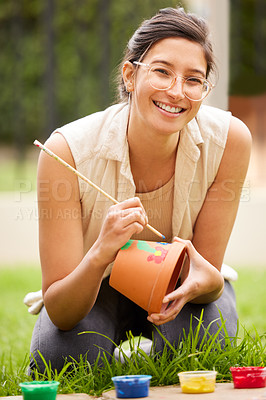 Buy stock photo Ceramic, pot and portrait of woman painting a craft container for plant in garden with creativity in hobby. Clay, art and artist with inspiration outdoor with paint brush, decoration or fun project