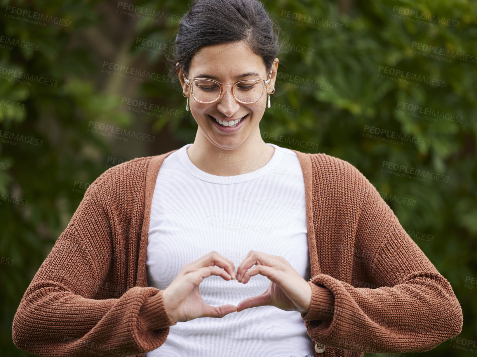 Buy stock photo Love, woman make a heart with her hands and smile for  or freedom outdoors. Emoji or happiness, affection and female person with hand gesture for positive motivation or support standing outside