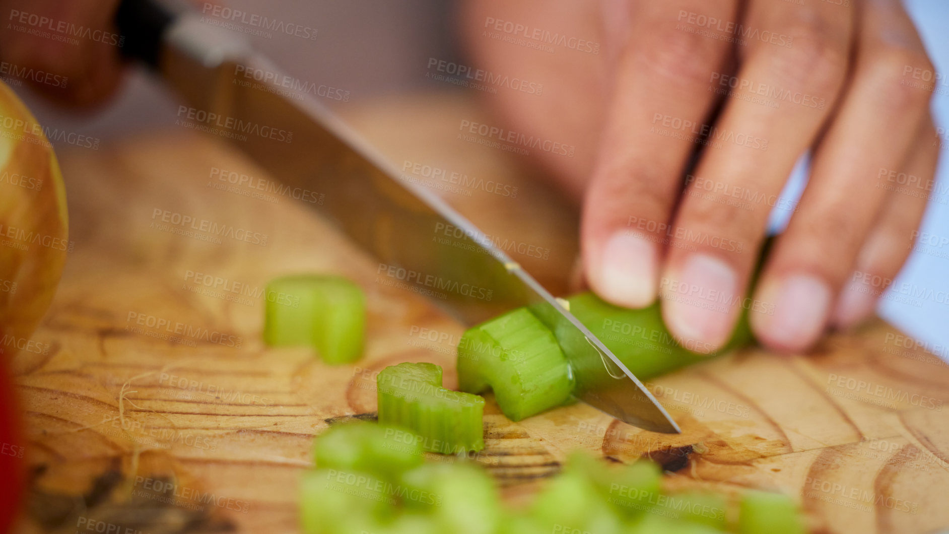 Buy stock photo Shot of a woman chopping up celery