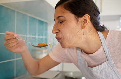 Buy stock photo Shot of a young woman tasting her food