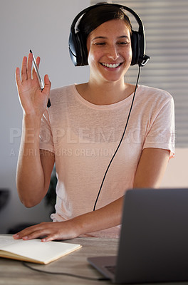 Buy stock photo Shot of a young woman having a video call while working from home