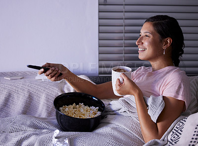 Buy stock photo Shot of a young woman watching tv at home