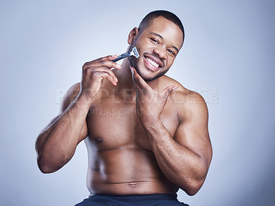 Buy stock photo Man, portrait and razor for beard in studio with skincare, grooming and hair removal for epilation. Topless, black person and happy with shaving for personal hygiene and self care on blue background