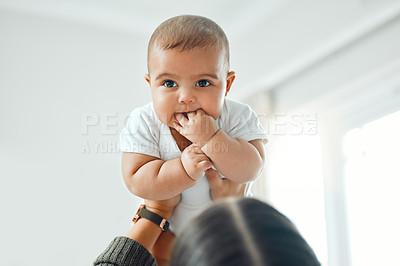 Buy stock photo Shot of a woman holding up her adorable baby boy