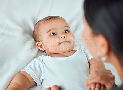 Buy stock photo Shot of an adorable baby boy lying on a bed