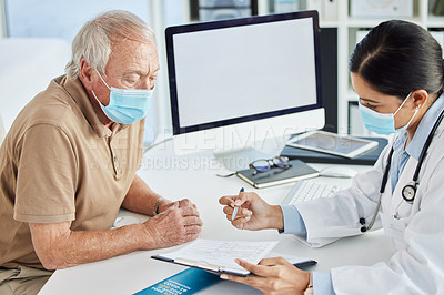 Buy stock photo Shot of a doctor wearing a face mask and sitting with her senior patient during a consult in her clinic