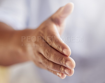 Buy stock photo Cropped shot of an unrecognizable businessman gesturing for a handshake while standing in his office