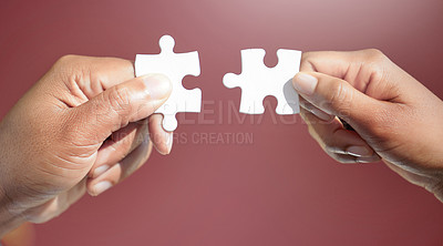 Buy stock photo Hands, puzzle and jigsaw for people in studio for connection, teamwork and link by red background. Colleagues, game and toys for synergy, collaboration and strategy with problem solving in office