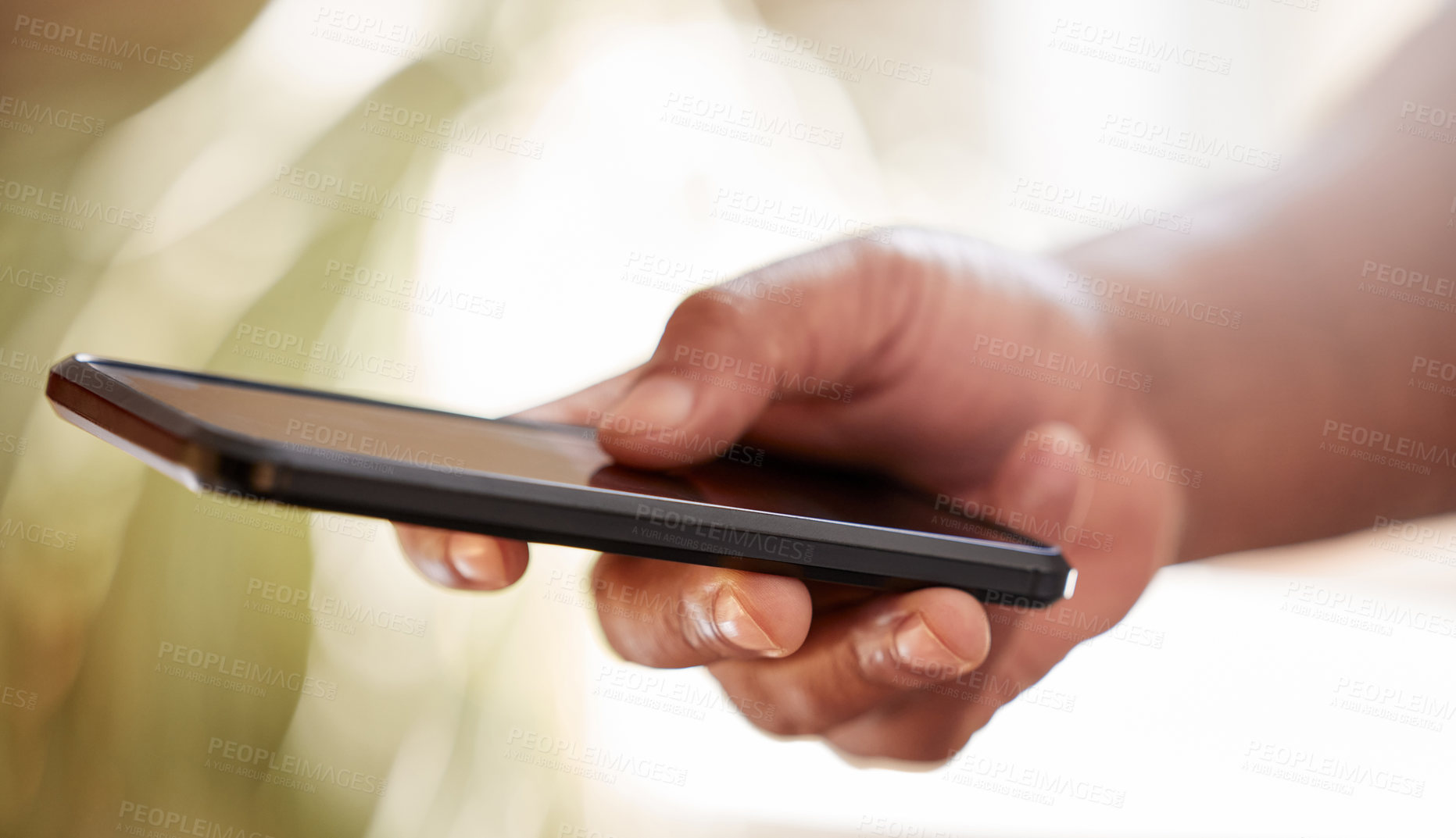 Buy stock photo Cropped shot of an unrecognizable businessman sending a text message while working on the office