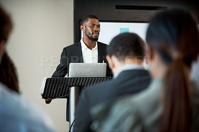 Buy stock photo Shot of a young businessman delivering a presentation during a conference