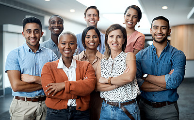 Buy stock photo Portrait of a group of confident young businesspeople working together in a modern office